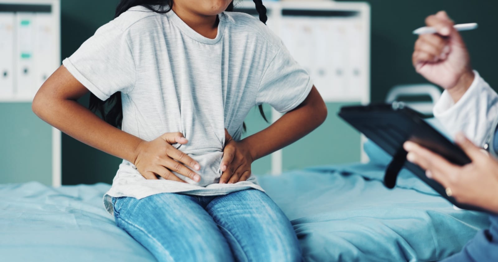 A patient discussing abdominal pain with a clinician
