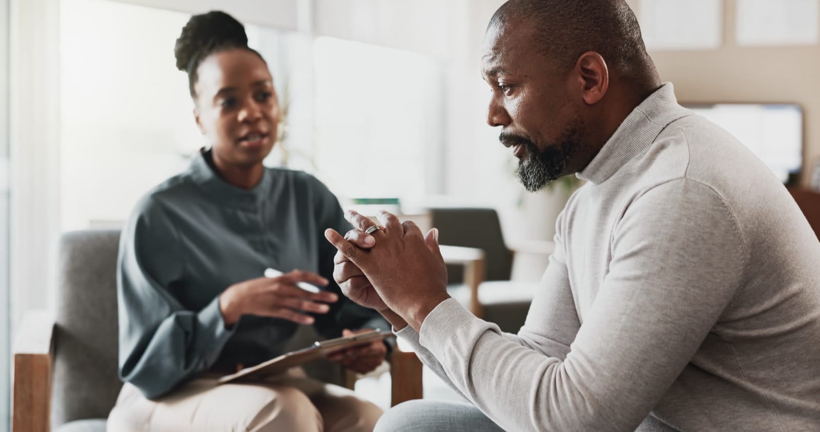 A mental health professional speaking with a patient