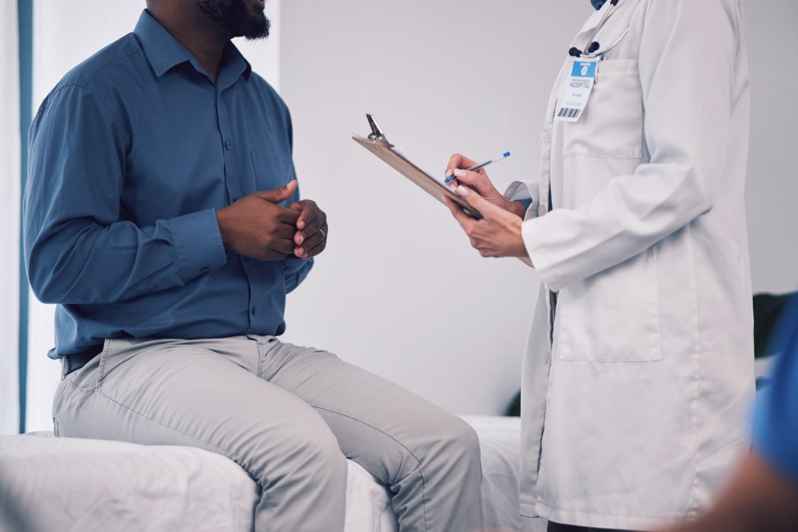 A urology consultation between a patient and clinician